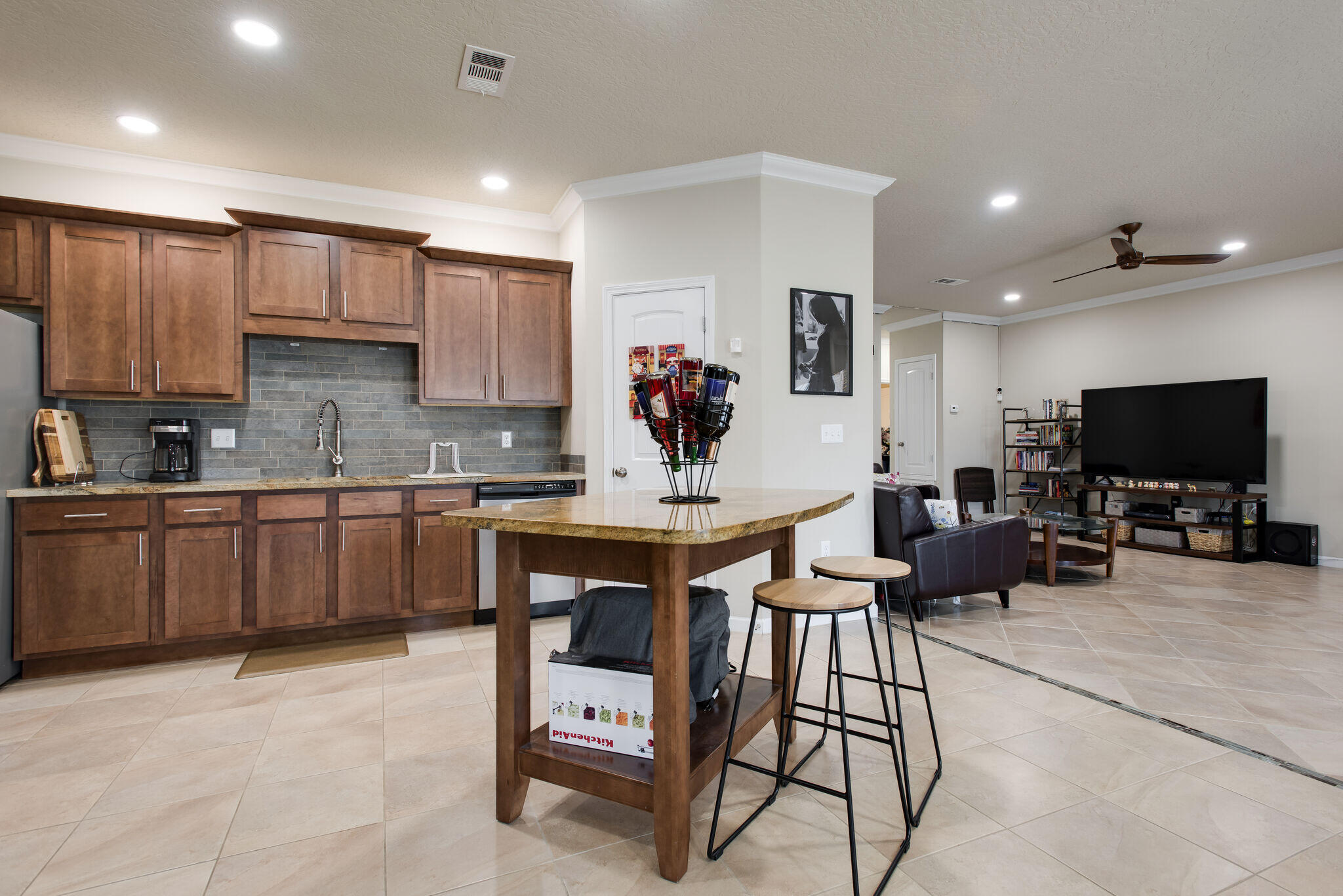 4600 Hermosa Road Crestview, FL 32539 - Photo 13 of 28 a living room with furniture a flat screen tv and kitchen view