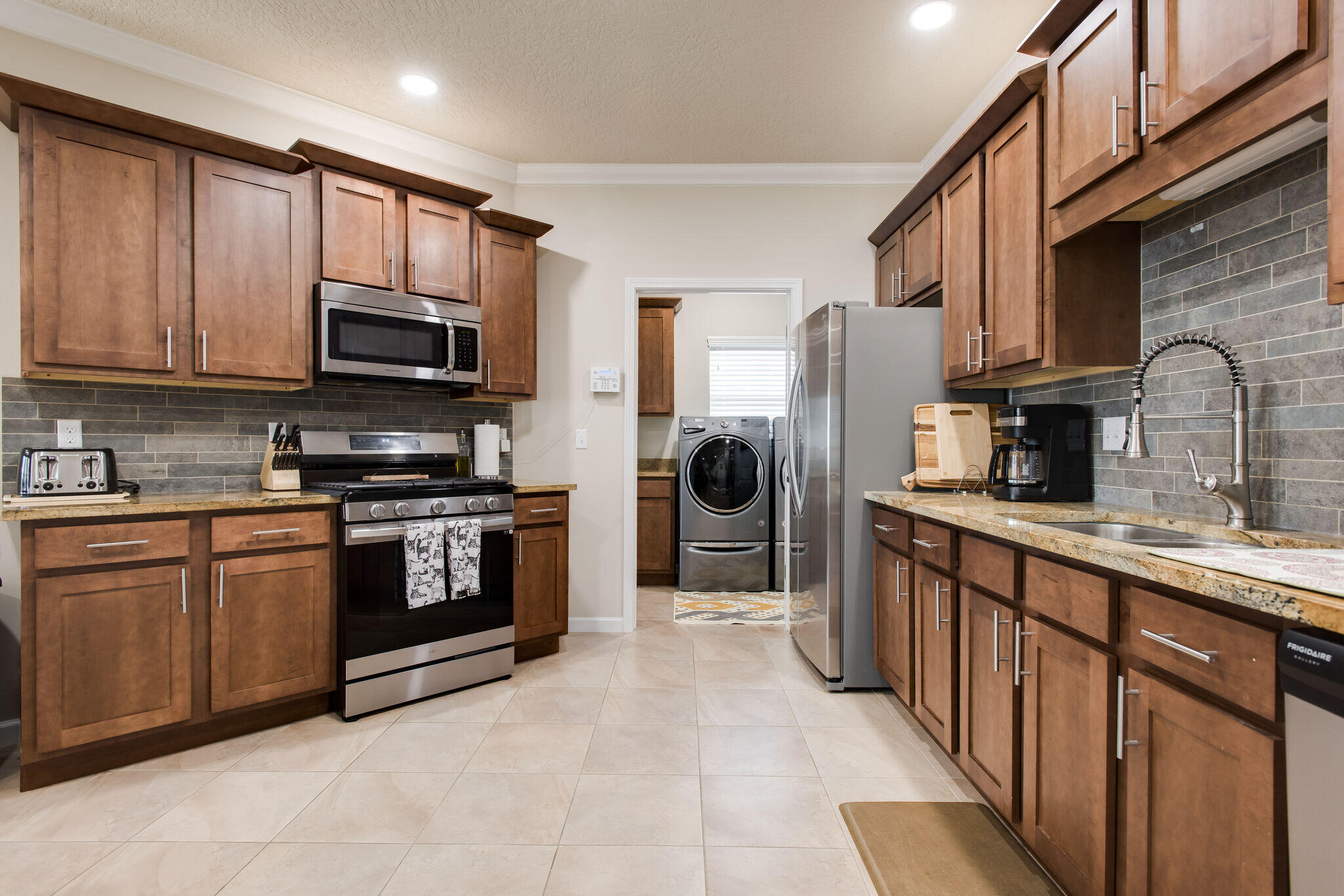 4600 Hermosa Road Crestview, FL 32539 - Photo 14 of 28 a kitchen with stainless steel appliances granite countertop a refrigerator a stove top oven a sink and dishwasher