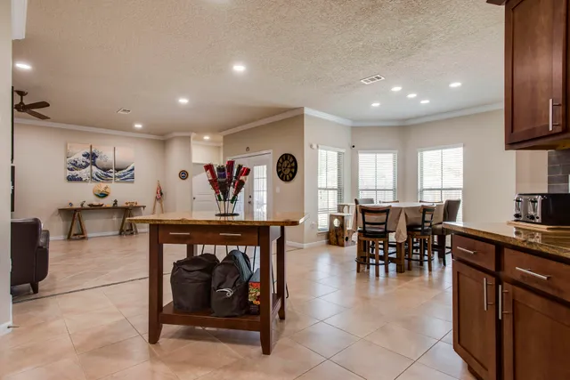 a view of a dining room with furniture and a large window