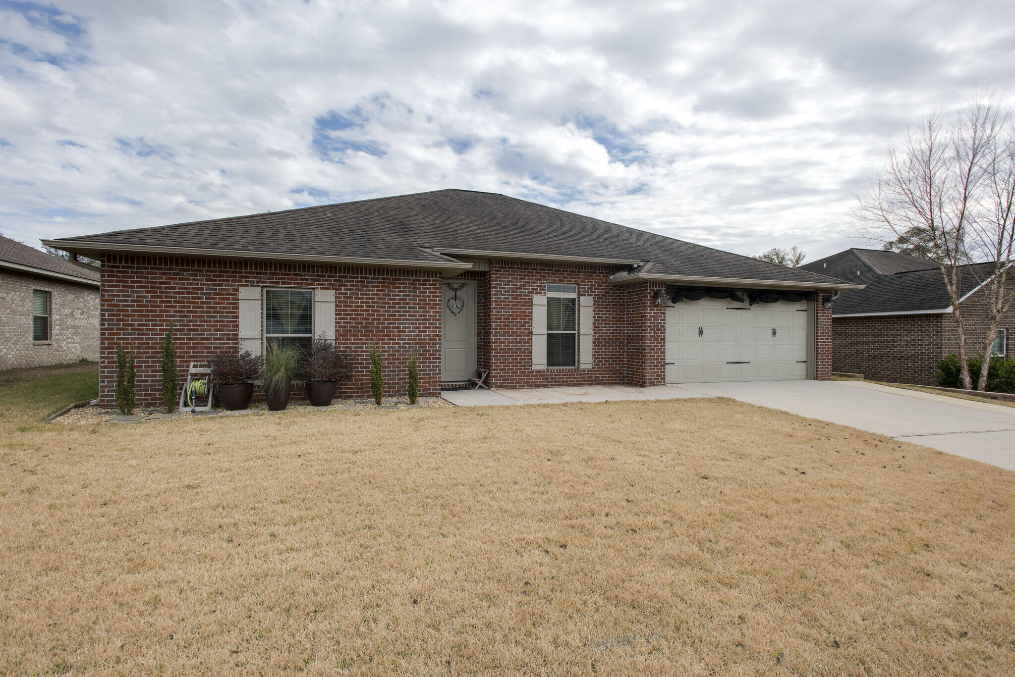 4600 Hermosa Road Crestview, FL 32539 - Photo 3 of 28 a front view of a house with a yard and garage