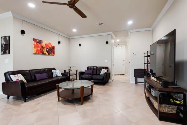 a living room with furniture and kitchen view