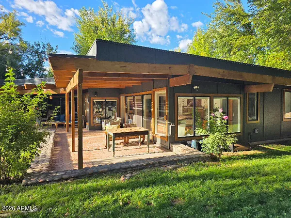 a view of a house with backyard porch and sitting area