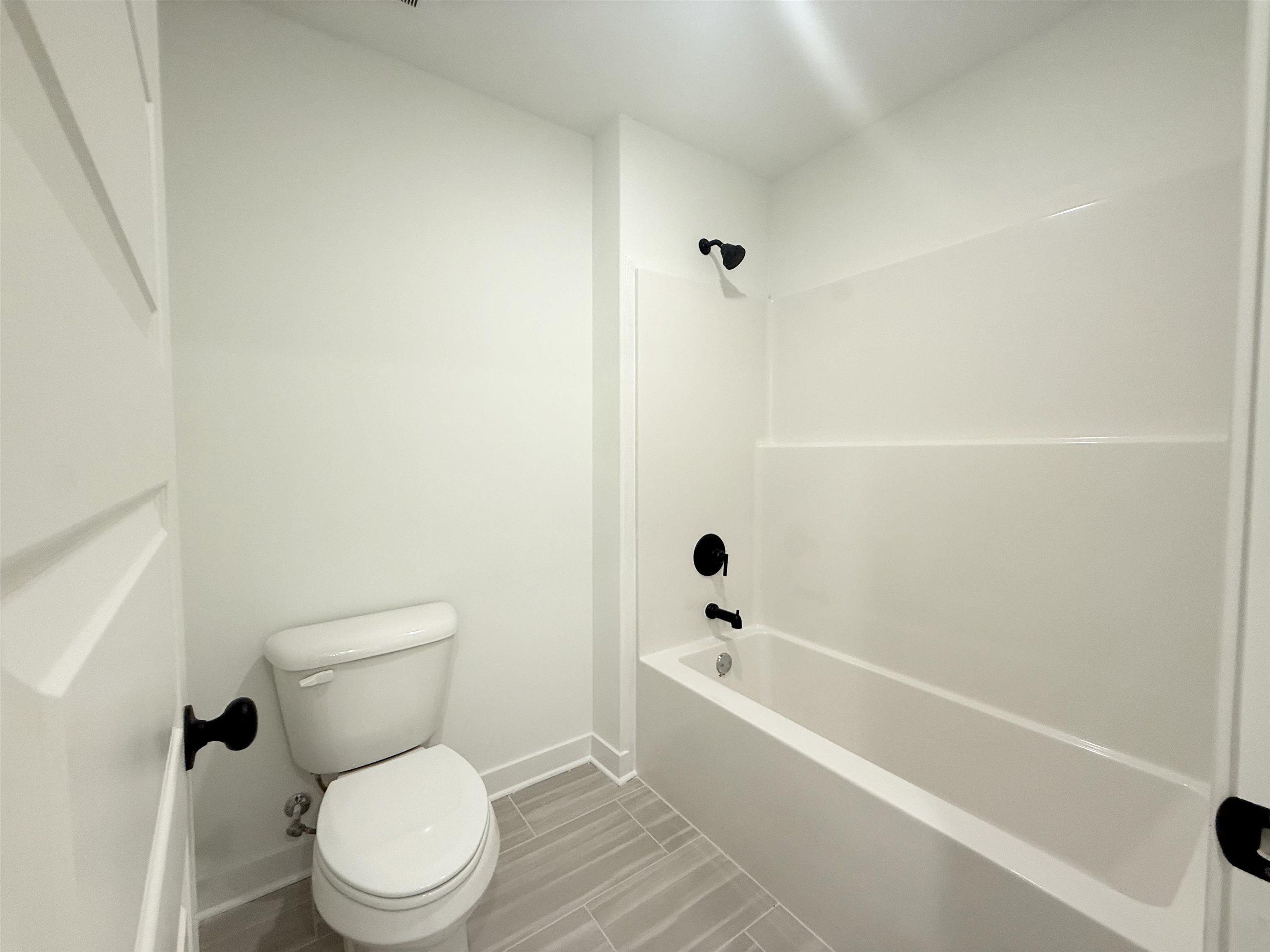 3060 Portage Drive Bartlett, TN 38133 - Photo 15 of 21 a white toilet sitting next to a bath tub