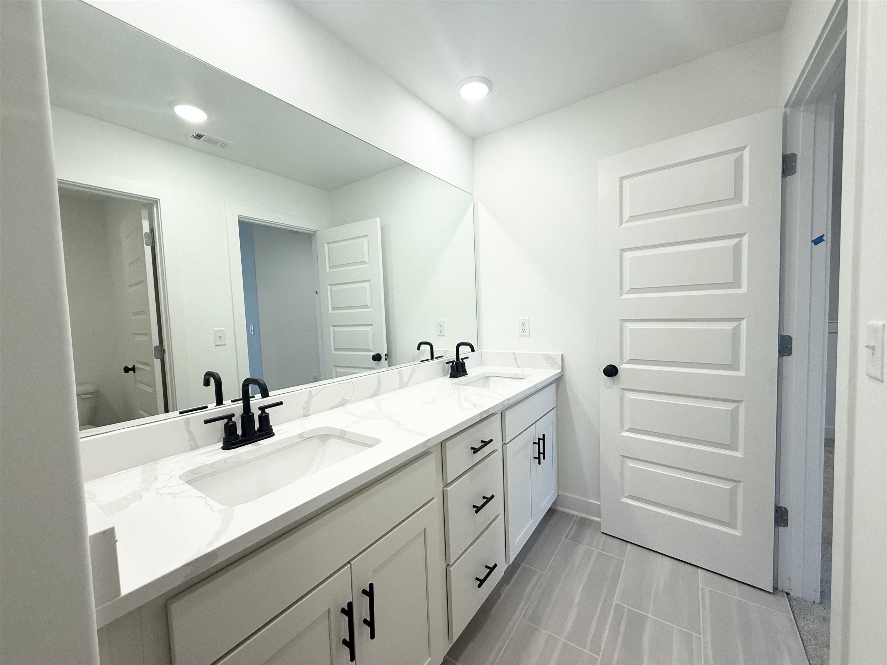 3060 Portage Drive Bartlett, TN 38133 - Photo 16 of 21 a bathroom with a double vanity sink a mirror and a bathtub
