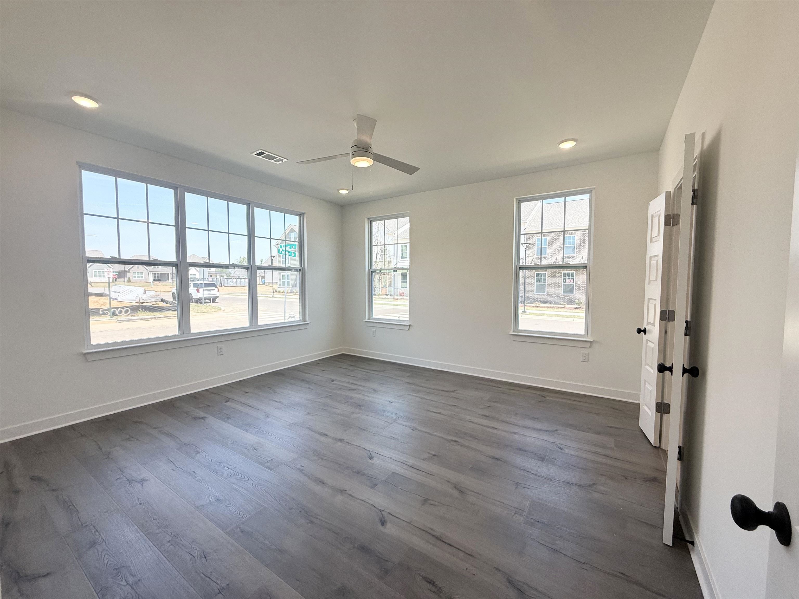 3060 Portage Drive Bartlett, TN 38133 - Photo 3 of 21 a view of an empty room with wooden floor and a window