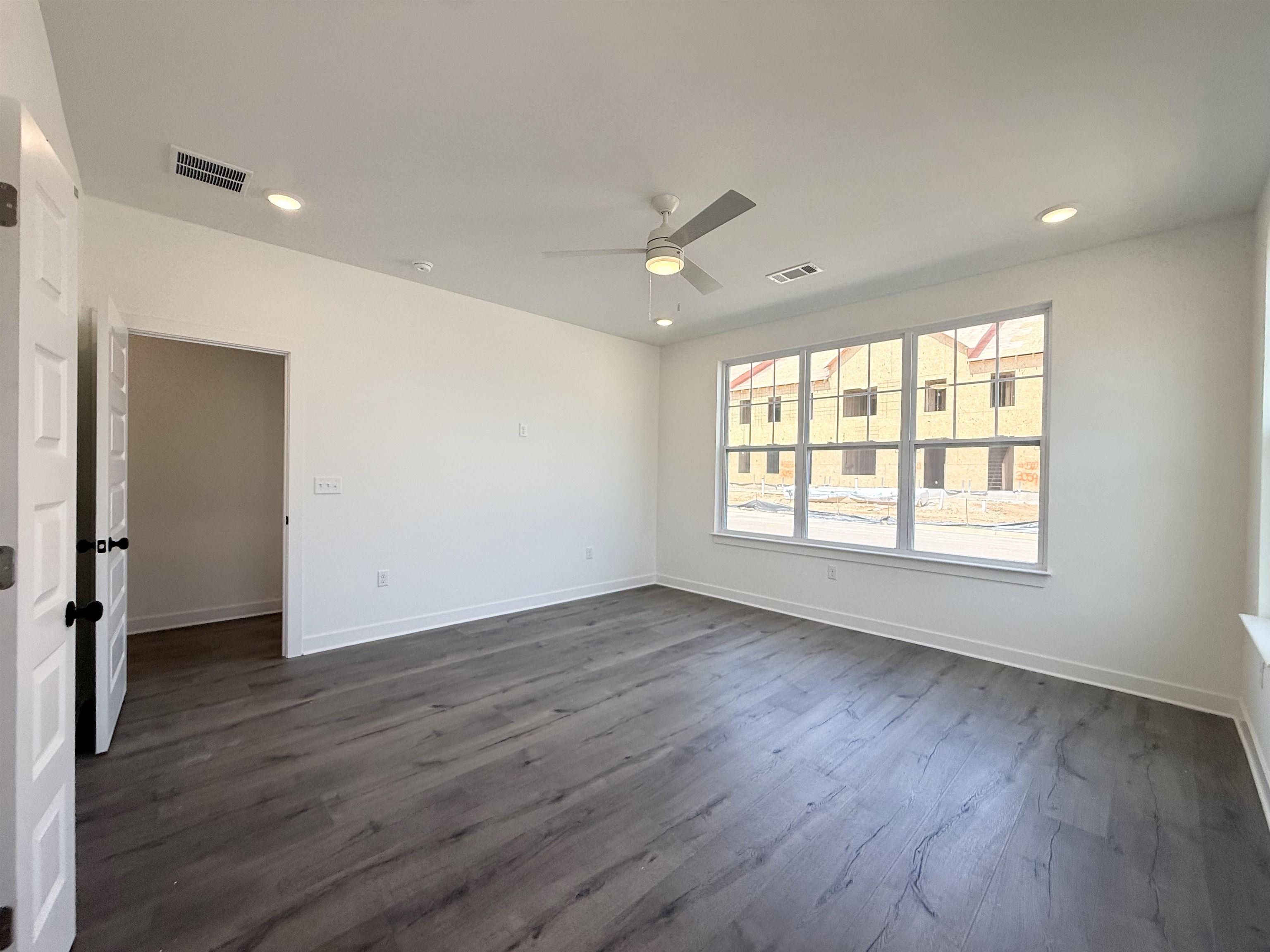 3060 Portage Drive Bartlett, TN 38133 - Photo 4 of 21 a view of an empty room with wooden floor and a window