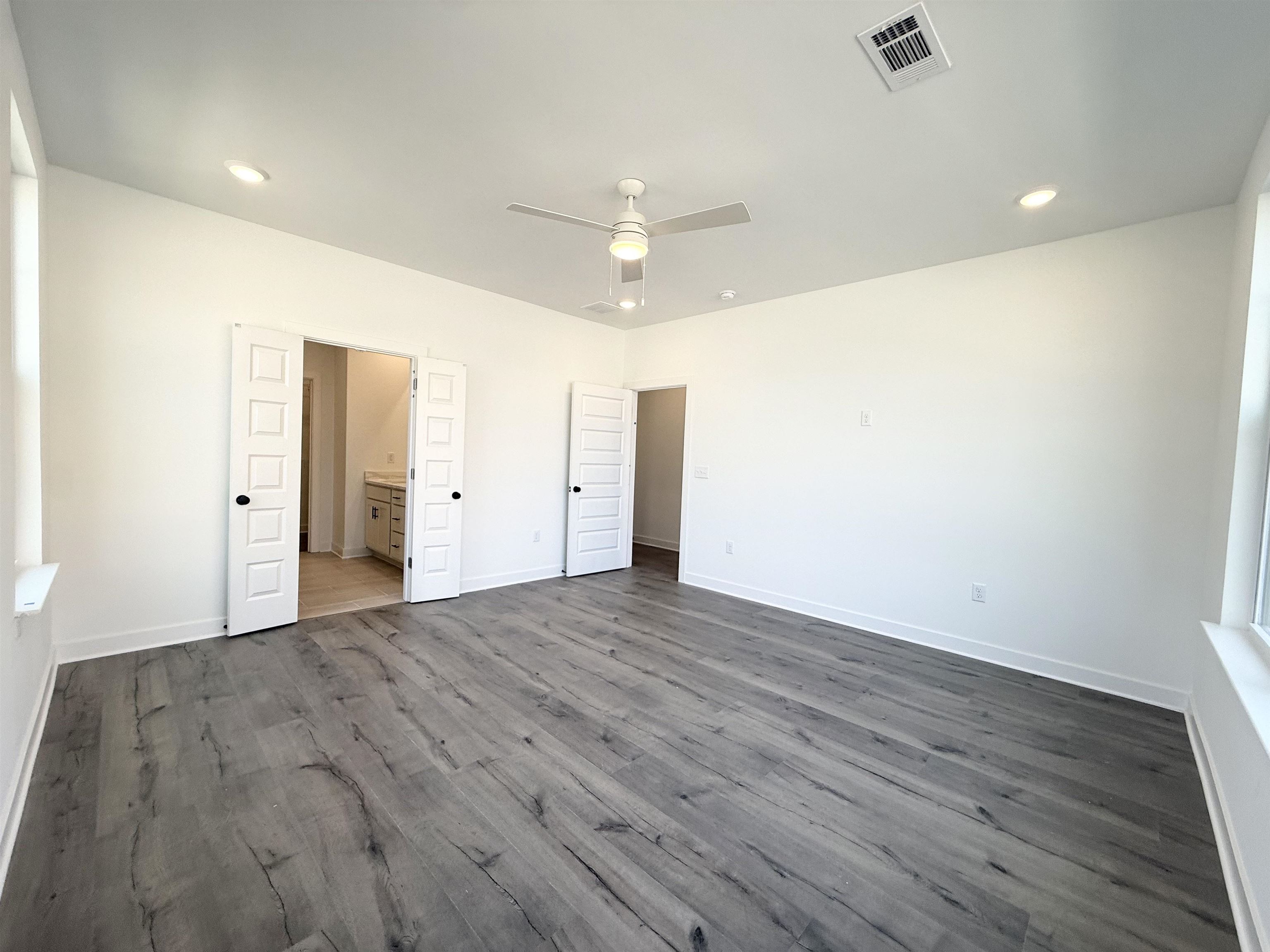 3060 Portage Drive Bartlett, TN 38133 - Photo 5 of 21 an empty room with wooden floor and ceiling fan