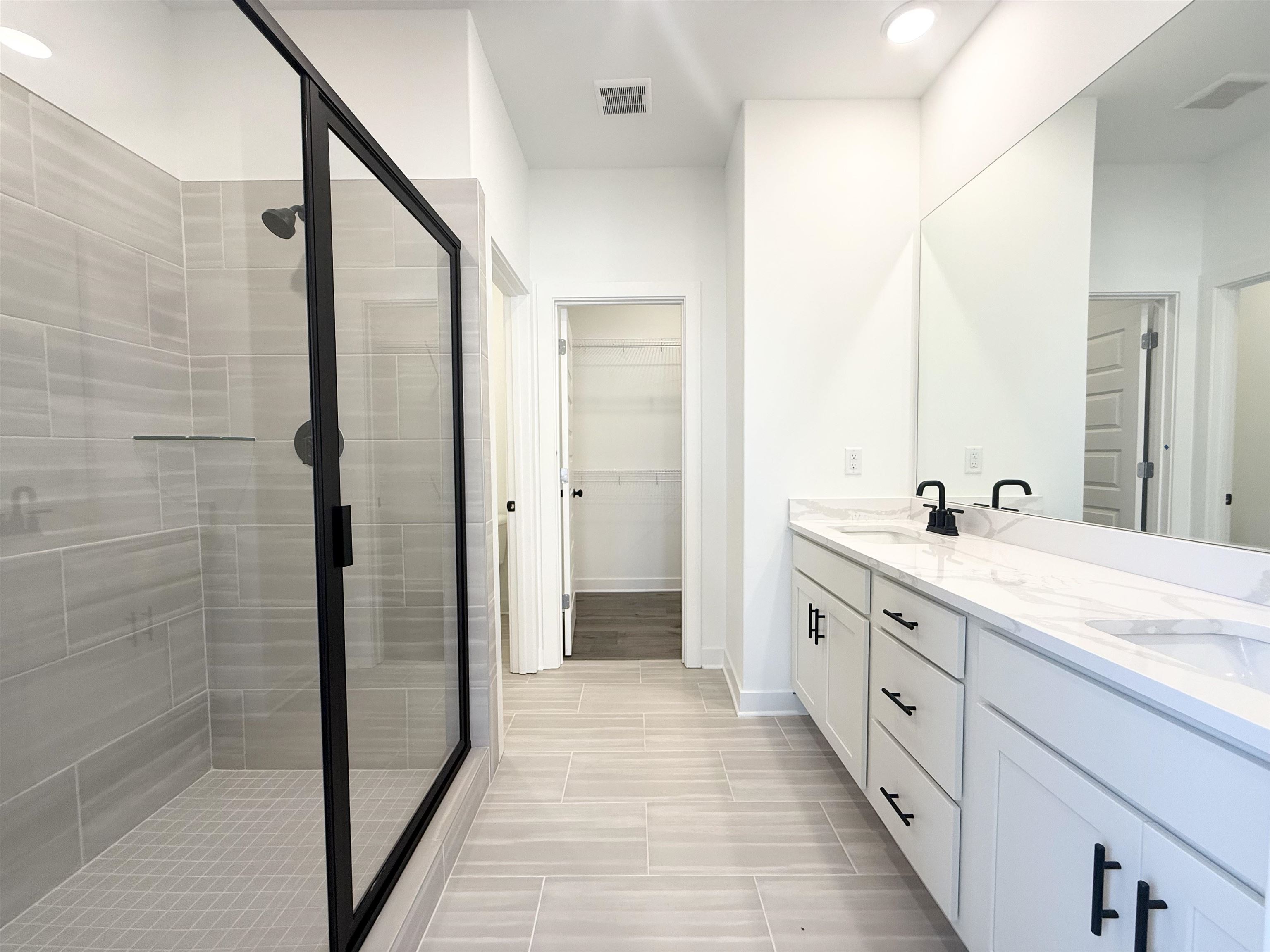 3060 Portage Drive Bartlett, TN 38133 - Photo 6 of 21 a spacious bathroom with a double vanity sink a mirror and a shower