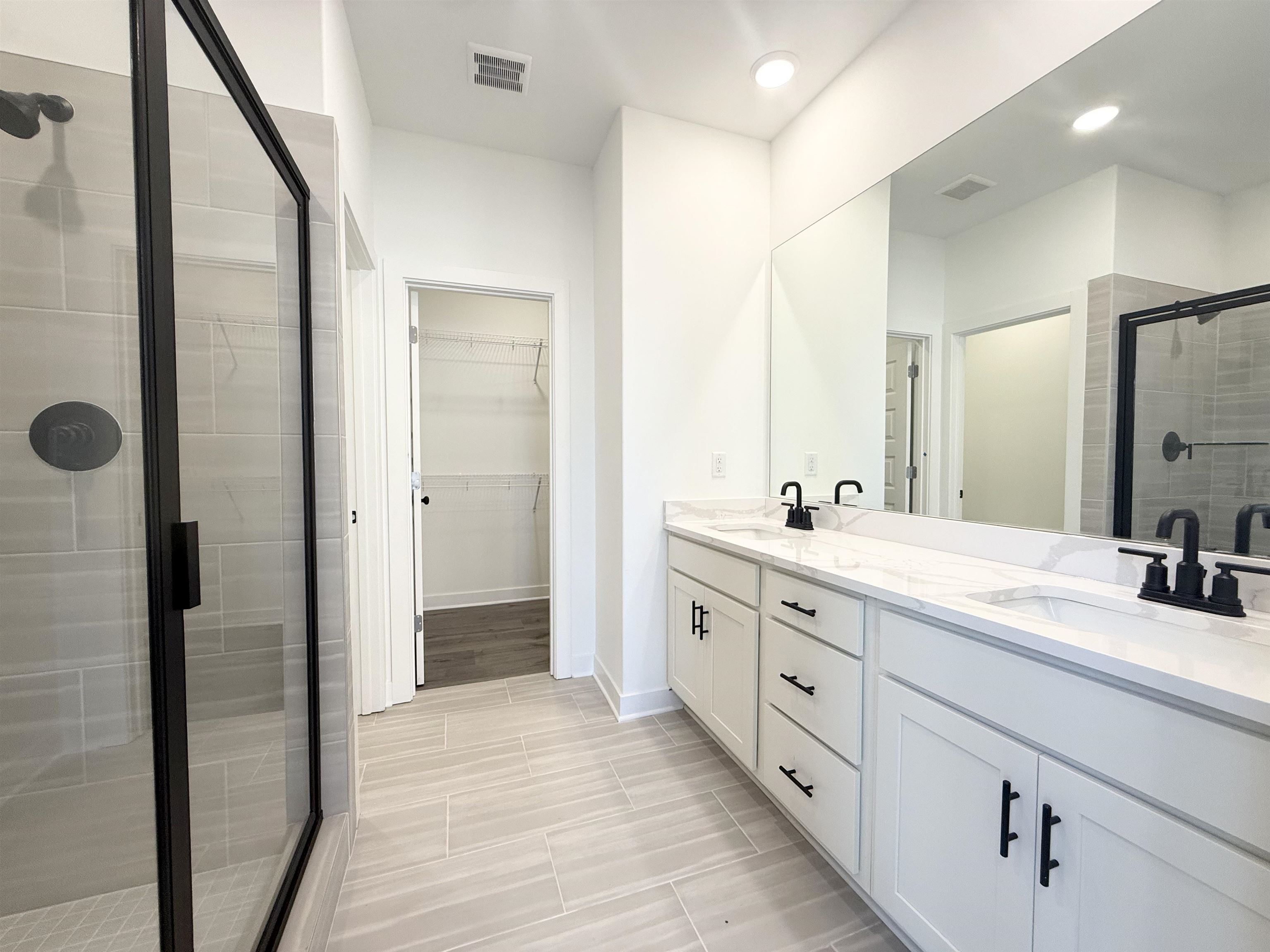 3060 Portage Drive Bartlett, TN 38133 - Photo 7 of 21 a spacious bathroom with a double vanity sink a mirror and shower