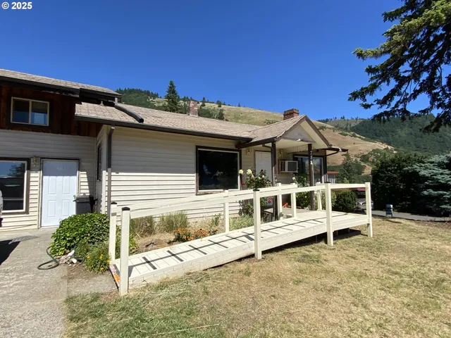 a view of a house with a wooden deck