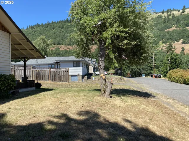 a view of a house with backyard and sitting area