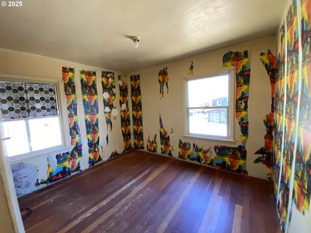 a view of a room with wooden floor and furniture