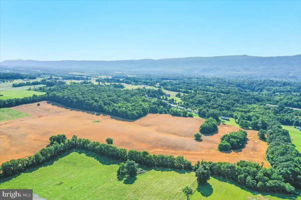 an aerial view of a house with yard