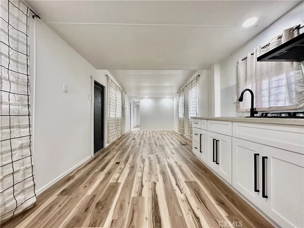6426 Valley View Drive, Unit 9 Joshua Tree, CA 92252 - Photo 14 of 23 a view of a kitchen with wooden floor and cabinets