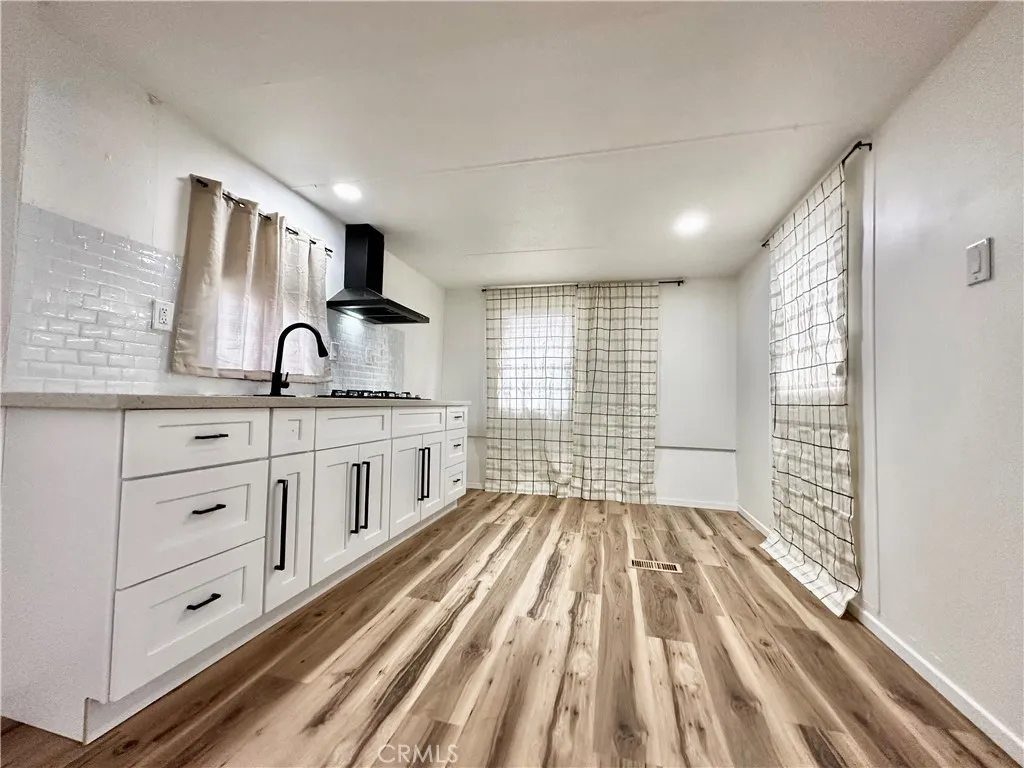 6426 Valley View Drive, Unit 9 Joshua Tree, CA 92252 - Photo 15 of 23 a kitchen with granite countertop white cabinets and white appliances