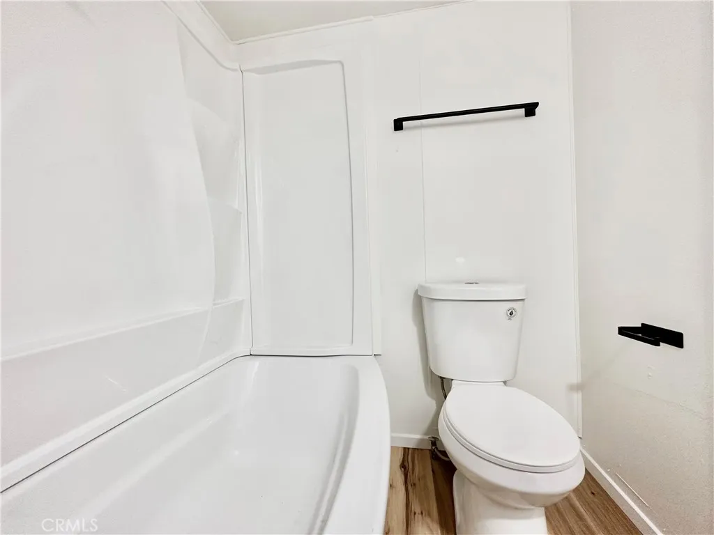 6426 Valley View Drive, Unit 9 Joshua Tree, CA 92252 - Photo 10 of 23 a white toilet sitting next to a bath tub