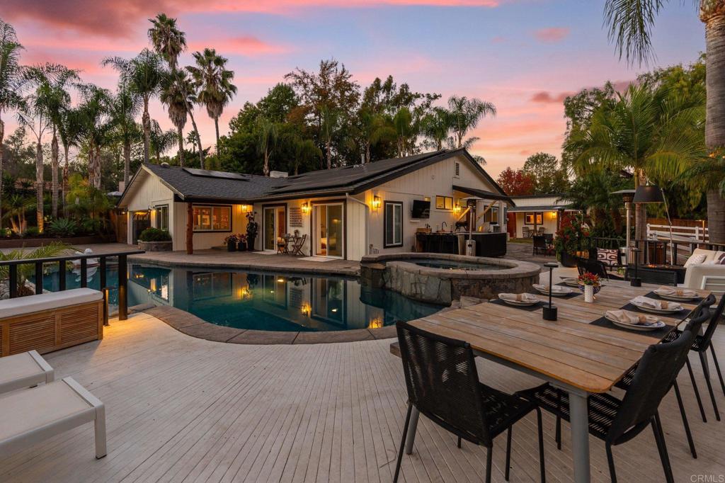 a view of a house with swimming pool and sitting area