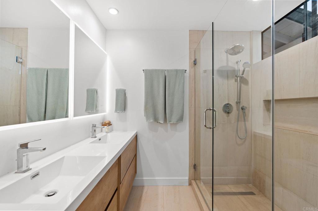 612 Lucylle Lane Encinitas, CA 92024 - Photo 18 of 47 a bathroom with a double vanity sink mirror and shower