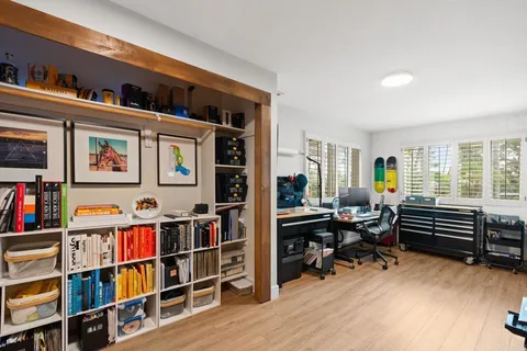 a living room with lots of furniture and book shelf
