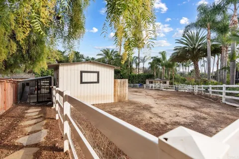 a view of a backyard with large trees