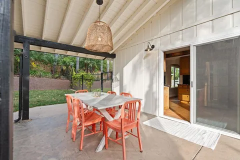 a view of an outdoor dining space with a table and chairs