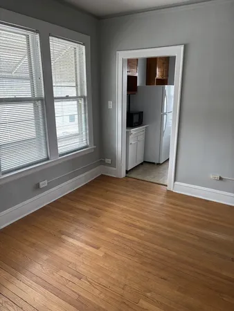 a view of a room with wooden floor and window