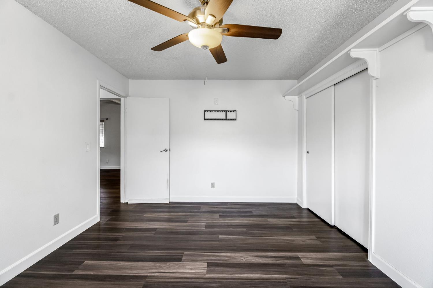 901 Valley Way Madera, CA 93637 - Photo 18 of 42 a view of an empty room with wooden floor