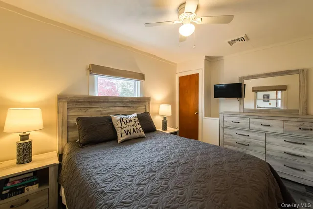 a bedroom with a bed and a television