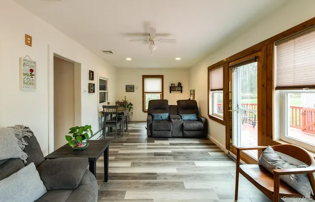 a living room with furniture and floor to ceiling windows