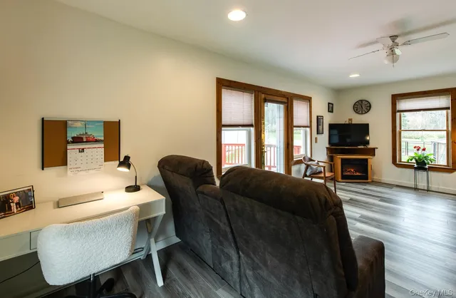 a living room with furniture a flat screen tv and a fireplace