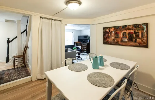 a kitchen with stainless steel appliances granite countertop a table chairs and a refrigerator