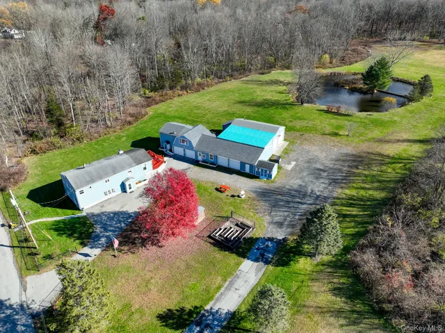 an aerial view of a house with garden space and outdoor seating