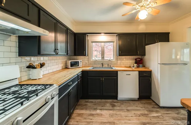 a kitchen with a refrigerator and a sink