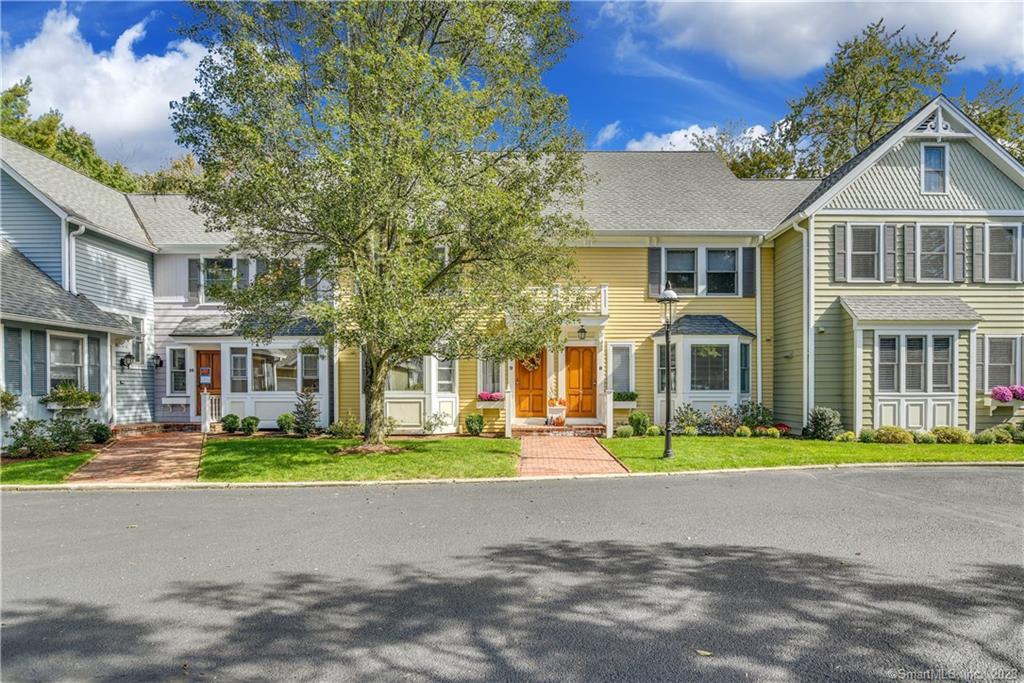 a front view of residential houses with yard and swimming pool