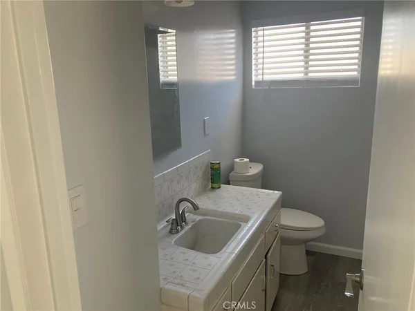a bathroom with a toilet and a window