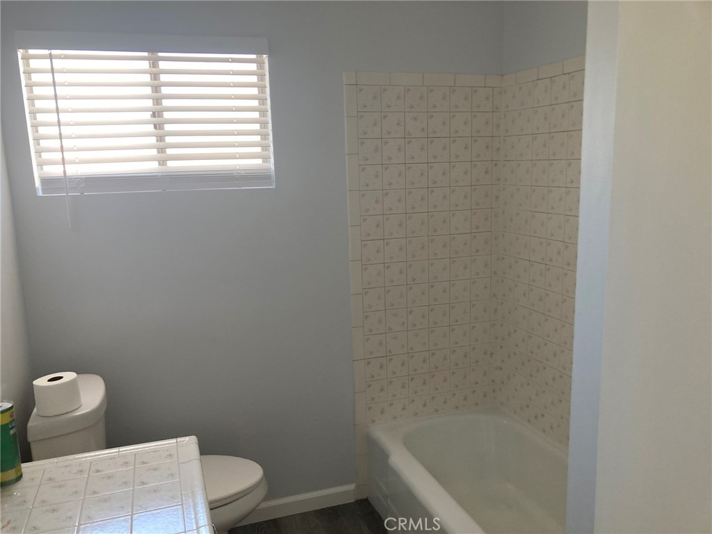 409 West Perdew Avenue Ridgecrest, CA 93555 - Photo 13 of 14 a bathroom with a toilet and a window