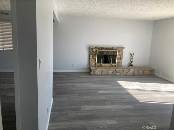 a kitchen with a sink cabinets and wooden floor