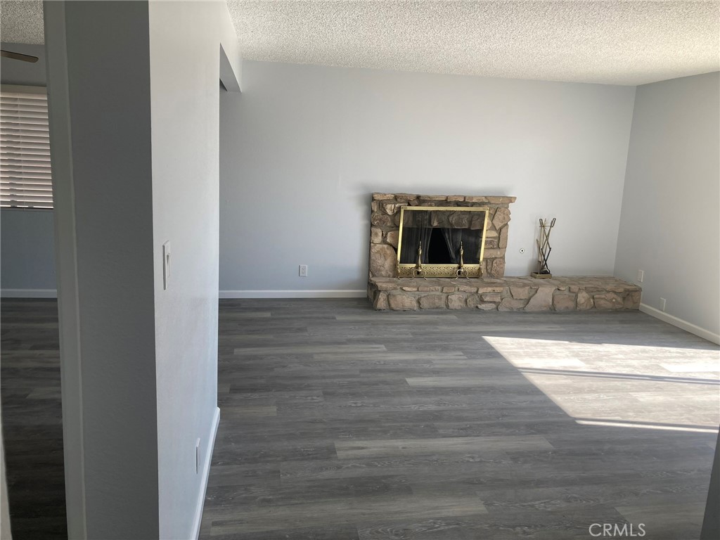 409 West Perdew Avenue Ridgecrest, CA 93555 - Photo 3 of 14 a view of a livingroom with wooden floor and a fireplace