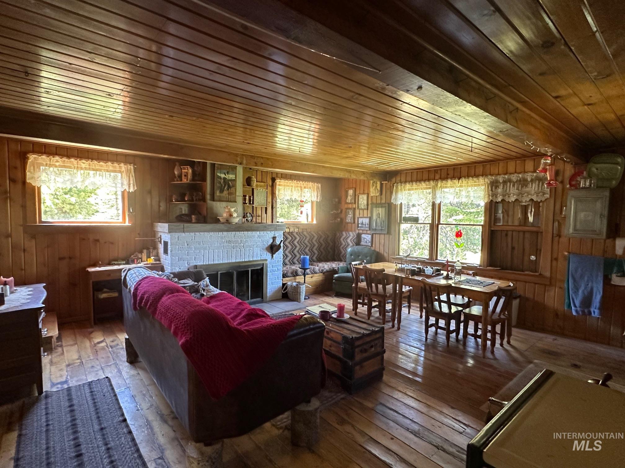 509 Deadline Road, Unit 2 Twin Falls, ID 83301 - Photo 22 of 28 Living area featuring wood-finish wall paneling, wood-finish flooring, and a wood-finish plank ceiling