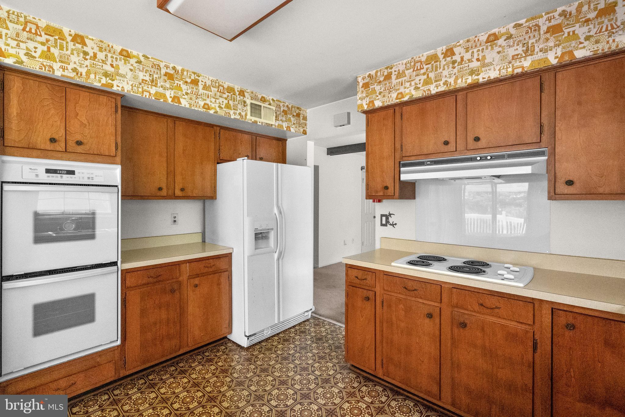 9509 Emory Grove Road Gaithersburg, MD 20877 - Photo 20 of 57 a kitchen with stainless steel appliances granite countertop a refrigerator and a stove top oven