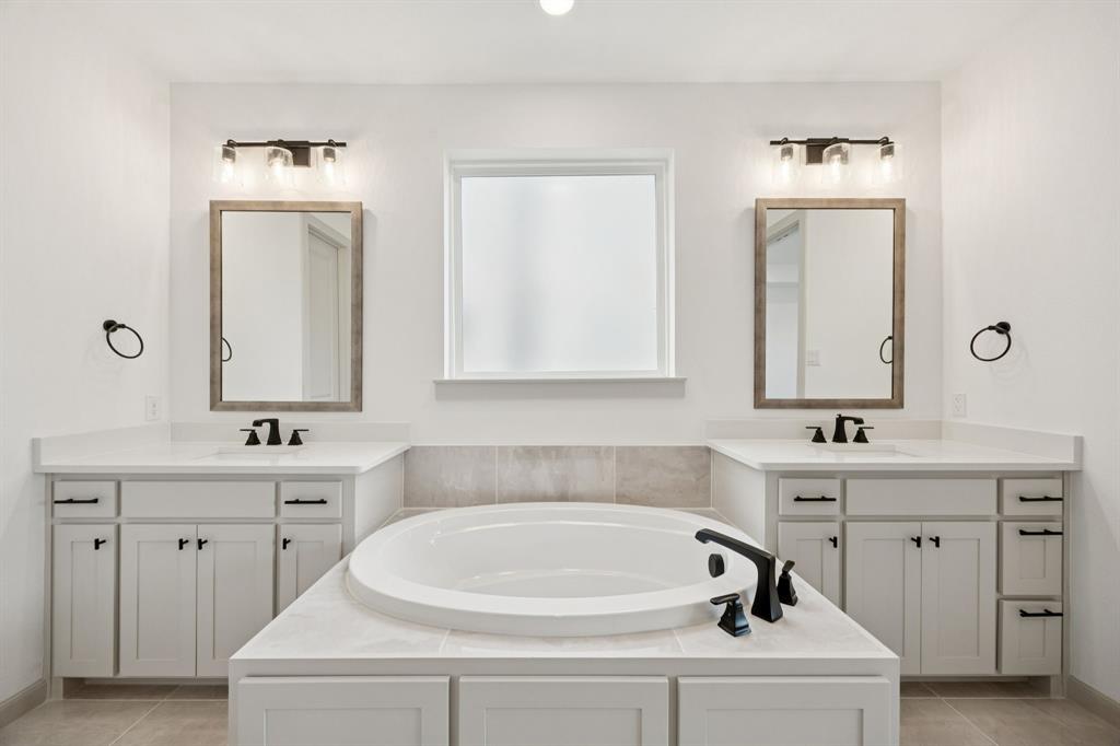 4180 Kestrel Street Prosper, TX 75078 - Photo 12 of 23 a bathroom with a sink and a mirror