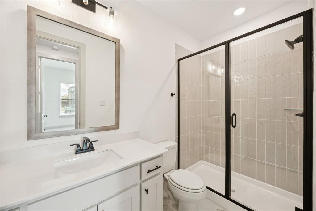 4180 Kestrel Street Prosper, TX 75078 - Photo 16 of 23 a bathroom with a sink a toilet and shower