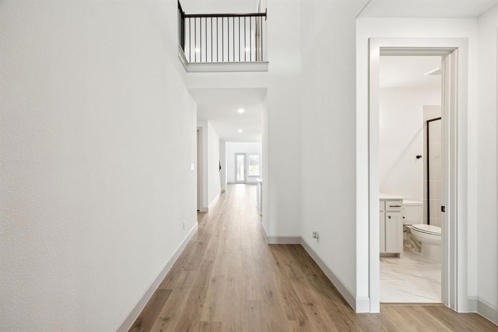 4180 Kestrel Street Prosper, TX 75078 - Photo 4 of 23 a view of a bathroom from a hallway