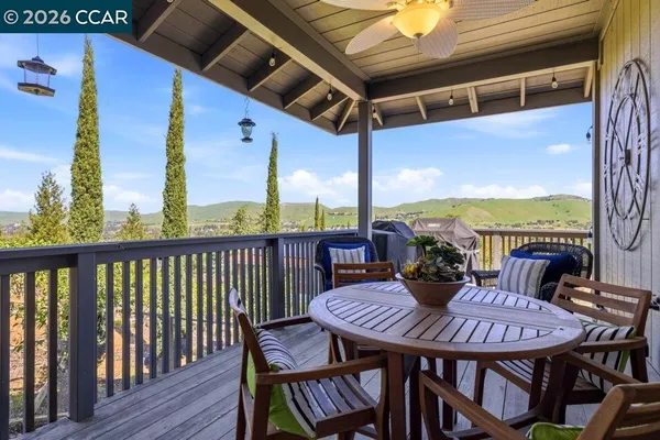 a view of a balcony dining table and chairs