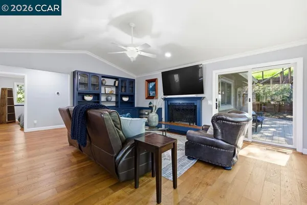 a living room with furniture a flat screen tv and a fireplace