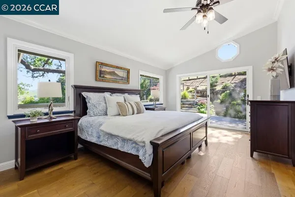 a bed sitting in a bedroom next to a window