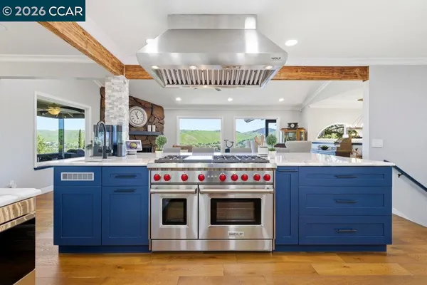 a kitchen with stainless steel appliances granite countertop a stove and a sink
