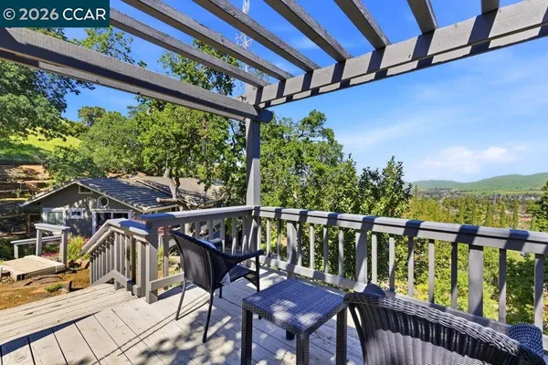 a view of a chairs and table in the balcony
