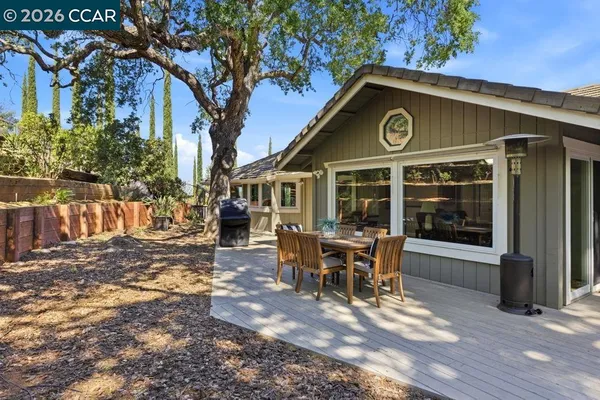a view of a house with a patio and a yard