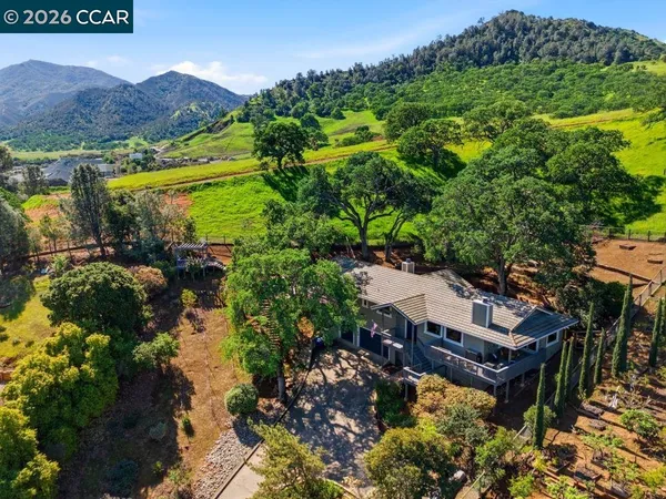 an aerial view of a house with mountain view